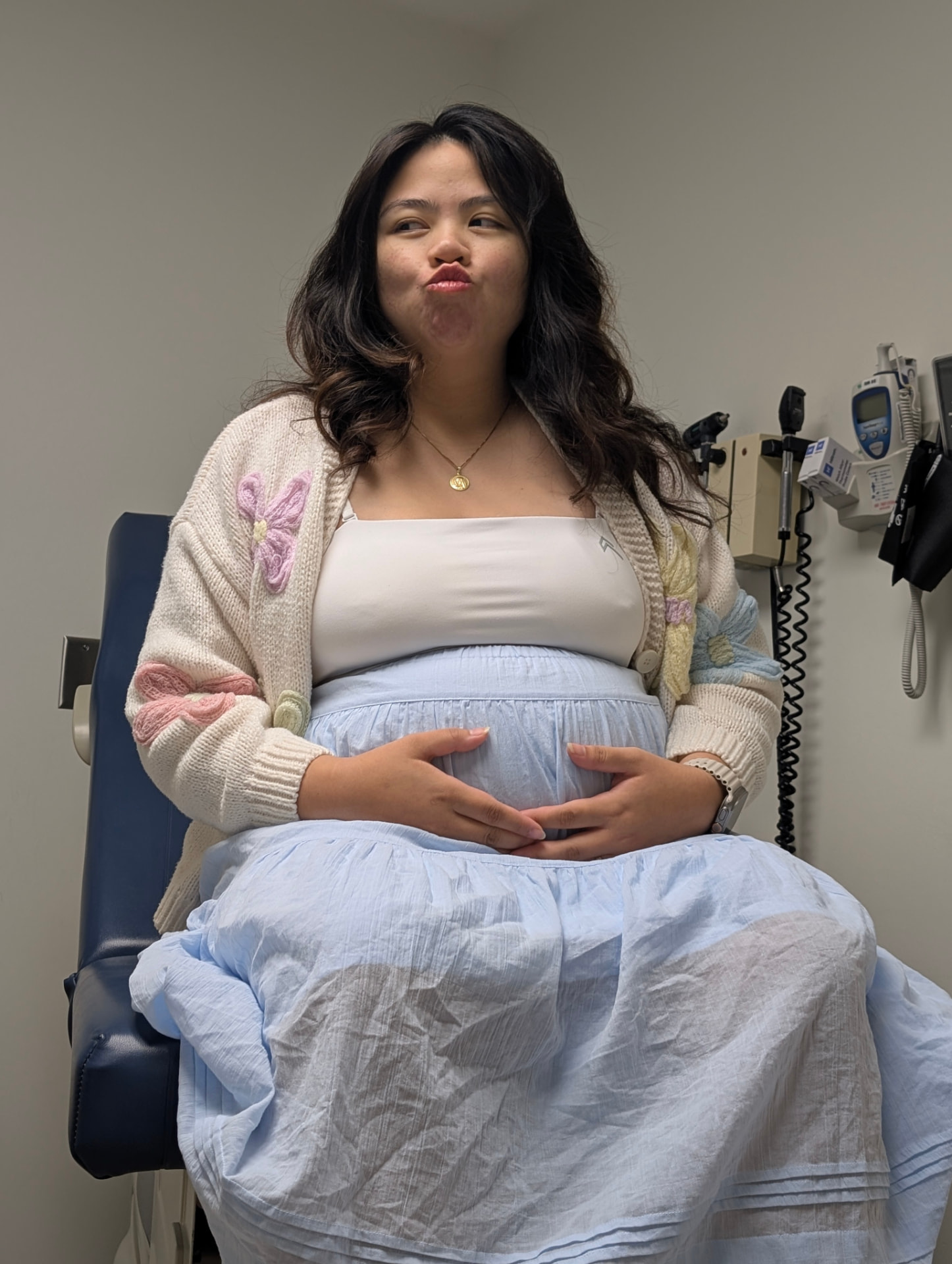 Sam seated during a pregnancy appointment